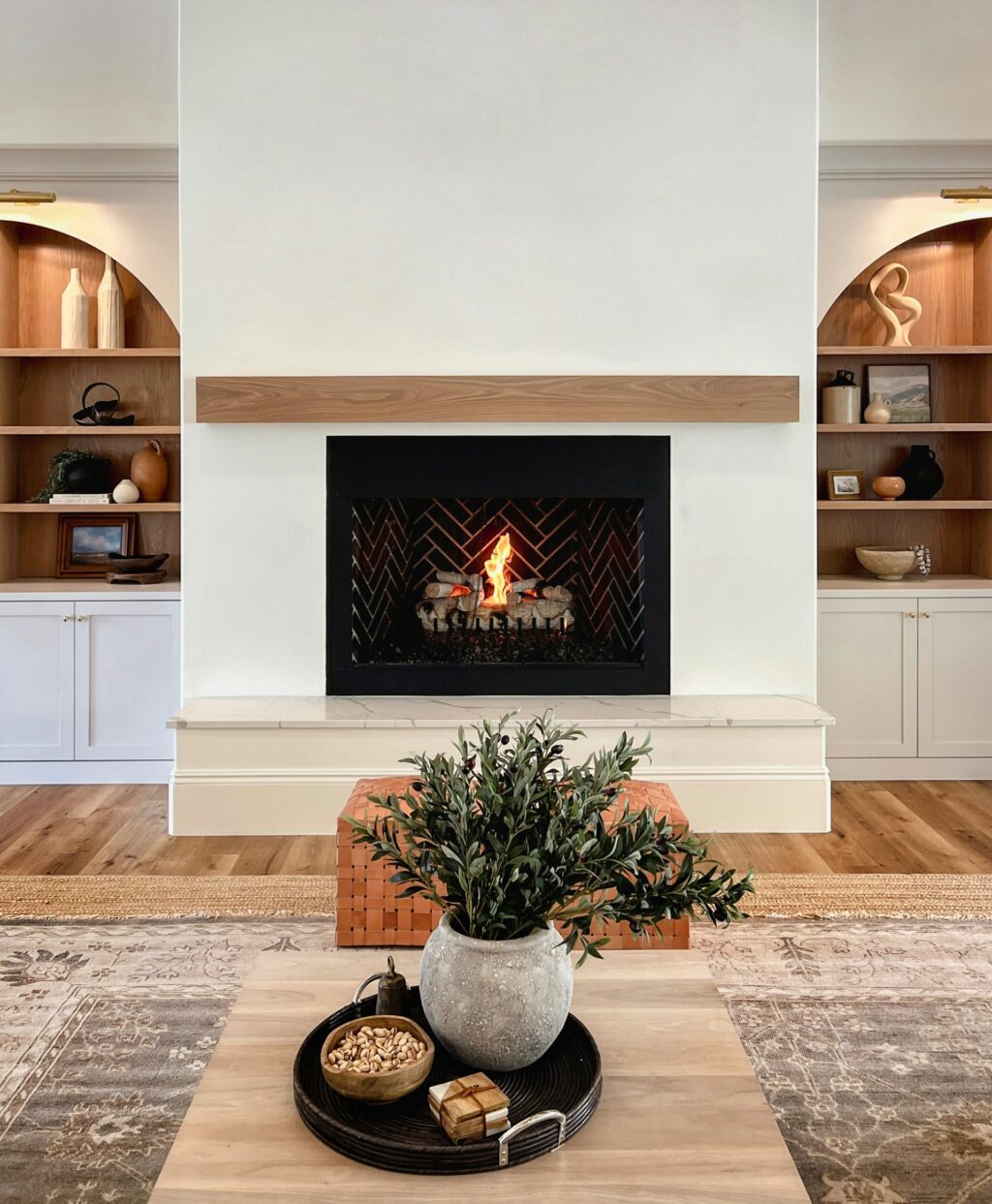 A white interior fireplace with a natural stone slab in front